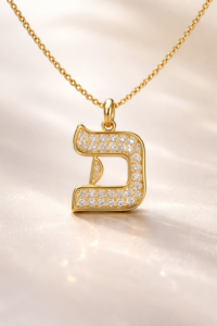 Gold Bet (ב) Hebrew letter necklace with diamond details representing the spiritual meaning of Hebrew letters art and sacred symbolism in Jewish culture.
