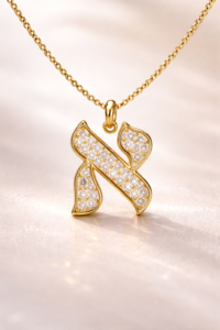 Gold Aleph (א) Hebrew letter pendant with diamonds illustrating the spiritual meaning of Hebrew letters art and divine unity symbolism.